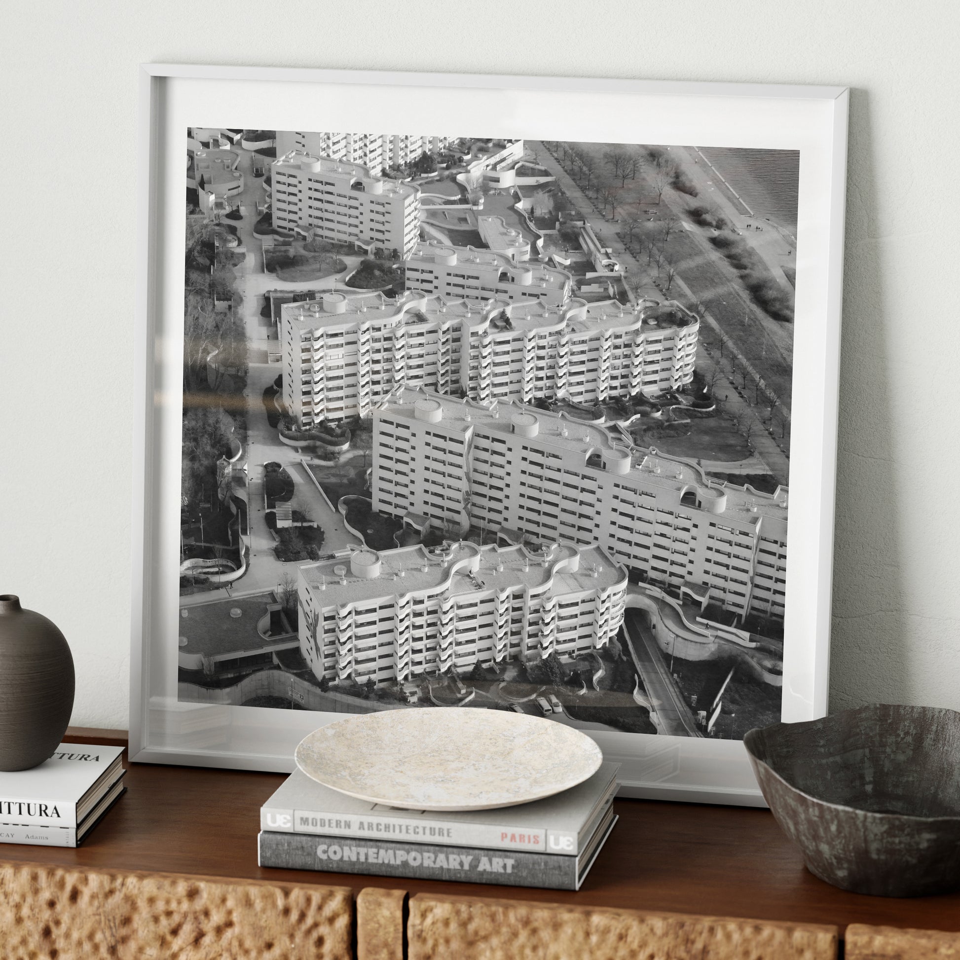 Black and white urban photography art print on a wood sideboard.